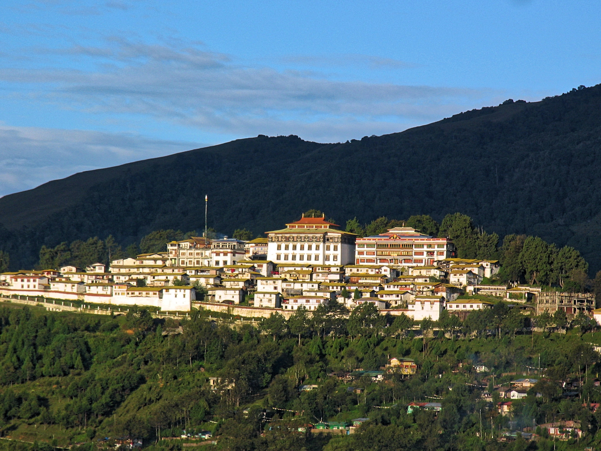 Tawang Monastery, the largest in India, spread across its green ridge in evening light